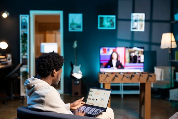 A worker at home uses a laptop and multiple screens to connect with team members during a video coference meeting.
