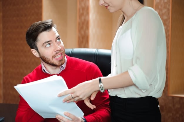 A manager is giving positive feedback to an employee in a one-on-one meeting. The setting looks supportive.