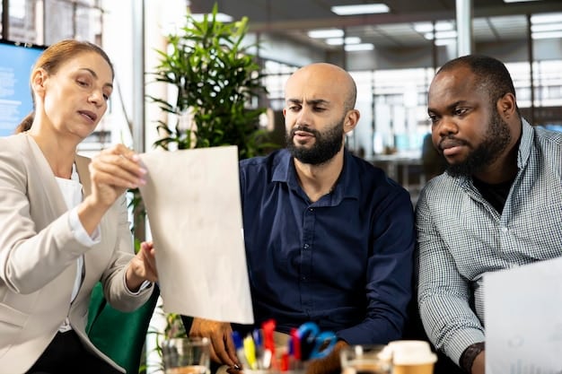 A leader facilitating a workshop with employees from different departments, using design thinking principles to solve a business problem. The leader is actively listening and encouraging participation from everyone in the room.