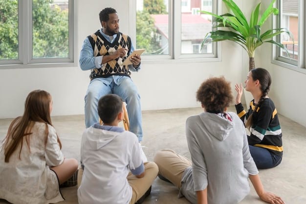 A diverse group receives training by a coach on Emotional Intelligence. The group sits at a table in a modern office and practices active listening and empathic responses. The coach gives feedback and gives tips.