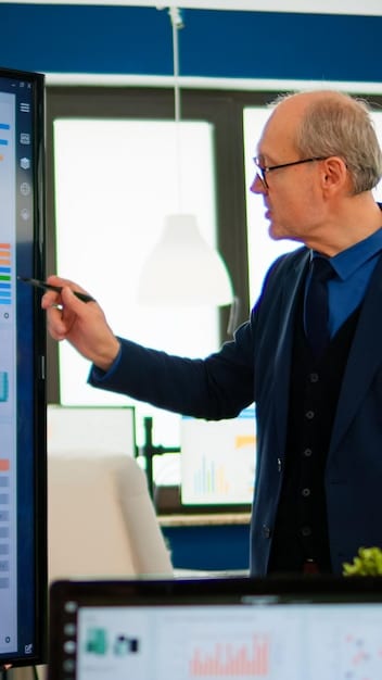 A leader presenting data visualizations on a large touchscreen display to a team, demonstrating a clear understanding and effective communication of technological concepts. The atmosphere is collaborative and engaging.