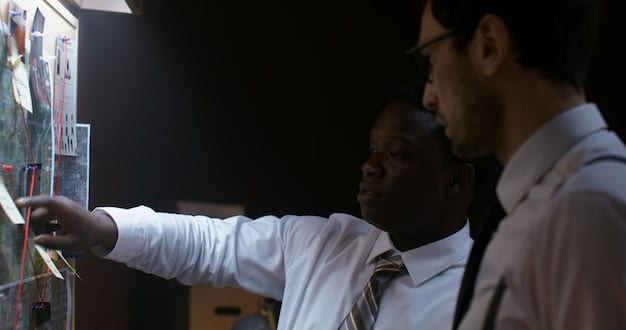 A diverse team of professionals collaborating around a large interactive whiteboard, analyzing data visualizations and brainstorming ideas.