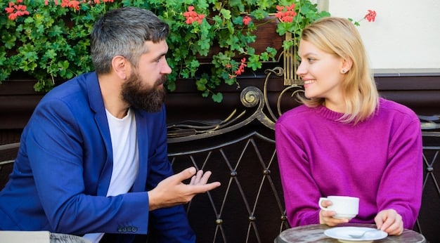 A close-up shot of two people engaged in a conversation. One person is speaking animatedly, while the other is making direct eye contact, nodding slightly, and has a focused expression, indicating intense listening.