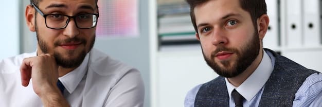 A close-up shot of two colleagues in a modern office, one listening intently as the other provides feedback. The focus is on their expressions, conveying respect and understanding. Natural light filters through the window.