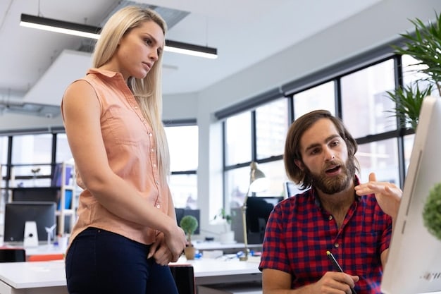 Two colleagues in an office setting, one listening intently to the other, who appears distressed. The listening colleague is making eye contact and offering a comforting gesture, demonstrating active empathy and support.