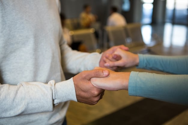 A close-up of two hands clasped together, symbolizing empathy and support during a difficult conversation. The setting is warm and inviting, suggesting a safe space for sharing feelings.