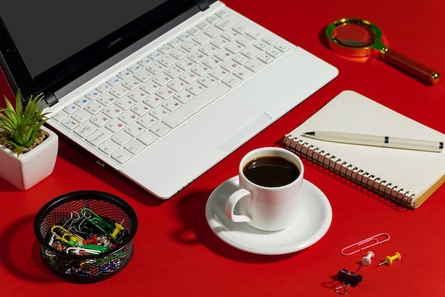 An organized desk with a laptop, notebook, pen, and a cup of coffee. The laptop screen displays project management software, symbolizing efficient task management.