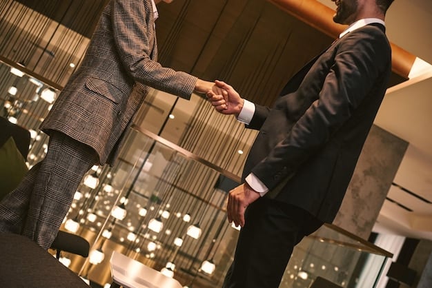 A close-up shot of two business professionals shaking hands after a successful networking event. They are smiling and making eye contact showing trust and a positive connection. The background is blurred to focus on the handshake and expression of their interaction.