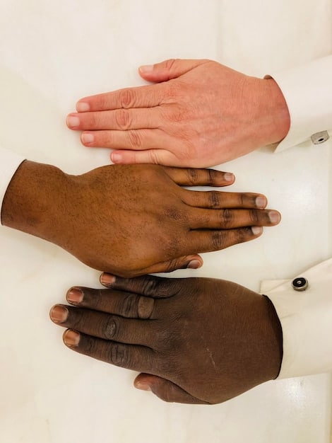 A close-up shot of hands of different skin tones shaking, symbolizing collaboration and unity. The background is blurred to keep the focus on the handshake and the message of diversity and inclusion. Hands belong to business people in professional clothing.