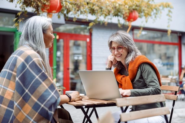 Two entrepreneurs, one older and one younger, discussing business plans over coffee in a bright, modern cafe in downtown San Francisco. Their laptops are open, and they are gesturing animatedly.