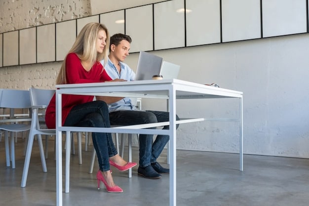 Two professionals sitting at a table in a bright and modern office, engaged in a deep and attentive conversation. They are both smiling and making eye contact, conveying trust and mutual respect. There are open notebooks and tablets on the table, suggesting a collaborative discussion.